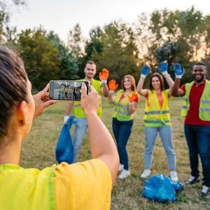 person taking photograph of group