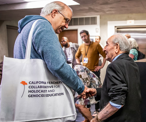  A teacher participant shakes hands with Joe, a Holocaust survivor, at the California Teachers Collaborative for Holocaust and Genocide Education’s first Summer Institute, June 2023.