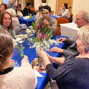 seniors and volunteers arranging flowers